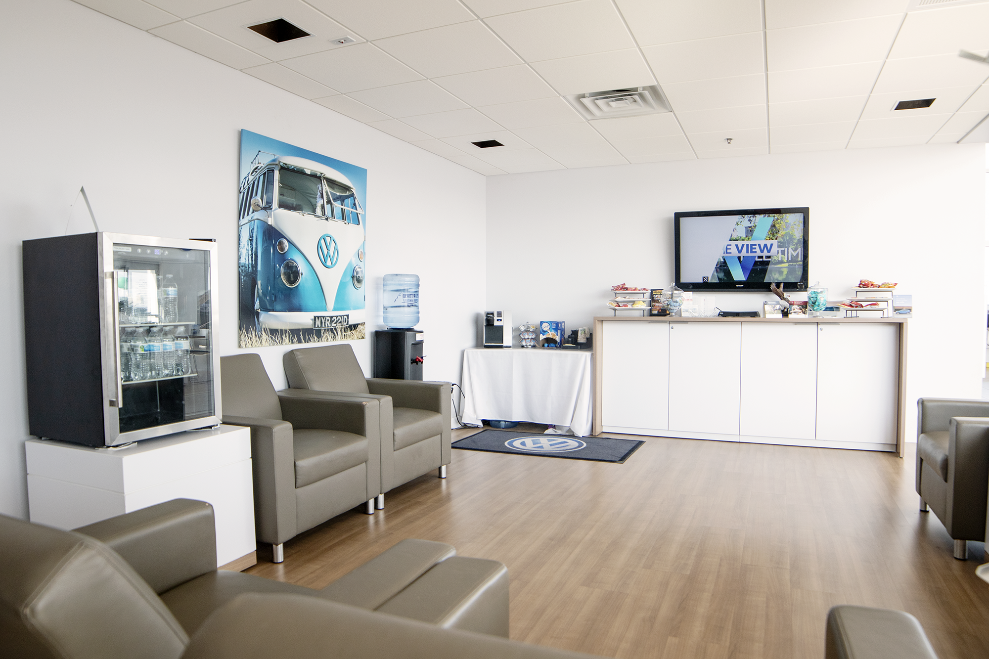 Showroom waiting area with seats and TV