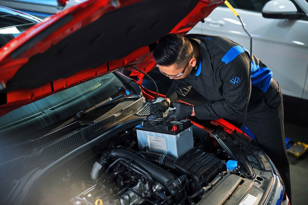 Certified technician executing high-precision Volkswagen battery installation