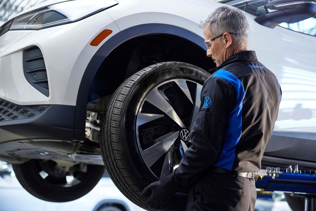 Certified Volkswagen Technician performing alignment